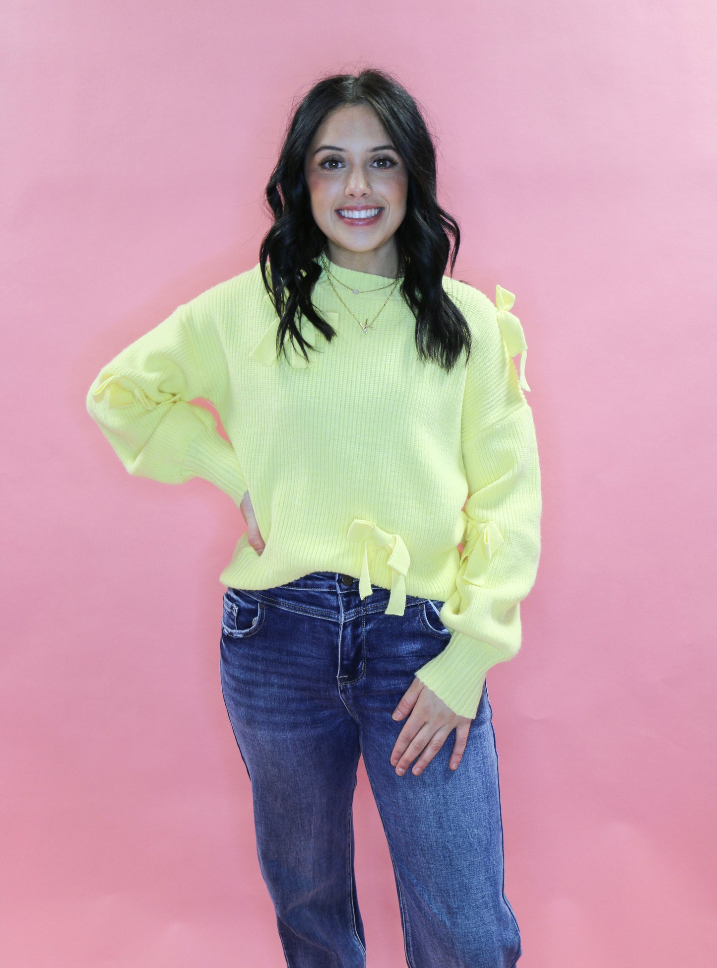 yellow knit sweater with bows
