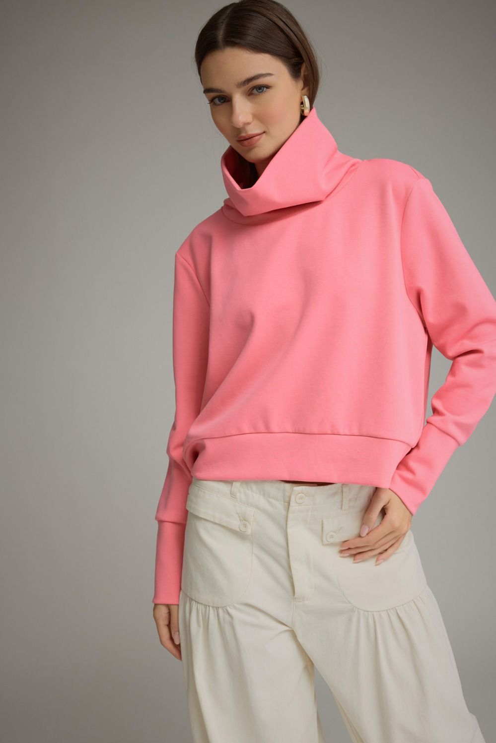 Solid long sleeve knit top with a fold-over high neckline